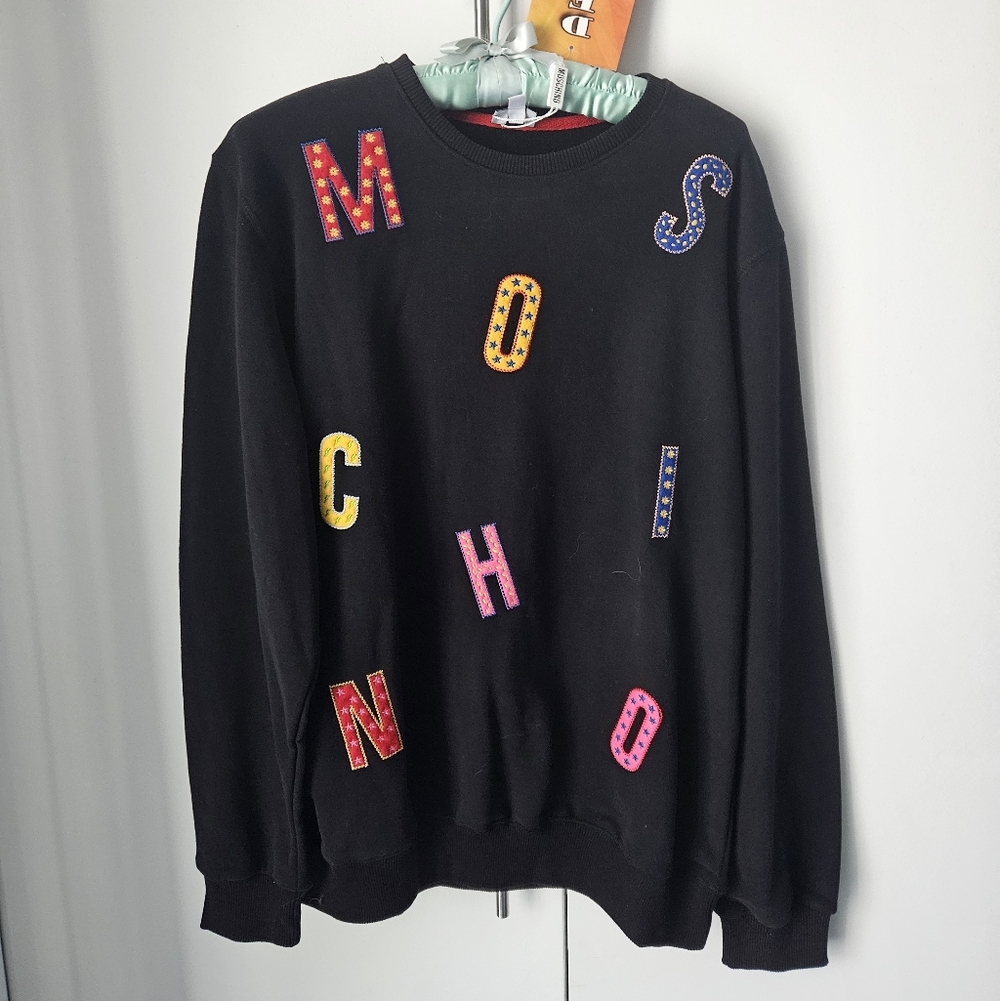 Moschino Black Crew Neck with Multicolor Lettering.  Flat friendly.
